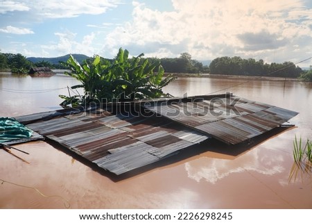 Flood water to the edge of the house's roof in Thailand. El Niño and La Niña phenomena. Royalty-Free Stock Photo #2226298245