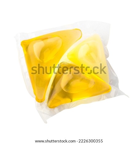Yellow capsule for laundry. Washing powder on a white background. isolated object