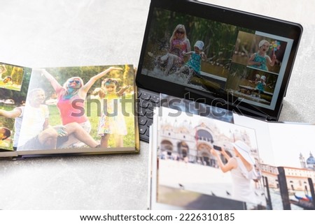 photobook album and tablet on the table