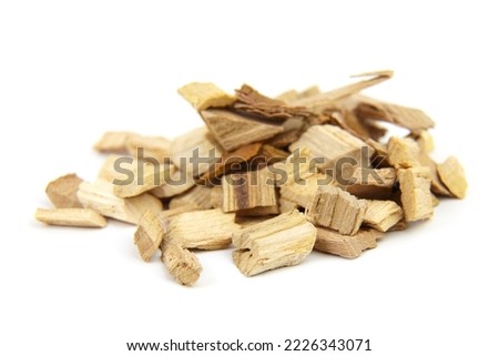 Wood chips for smocking isolated on white background. Natural apricot wood smoking chunks Royalty-Free Stock Photo #2226343071