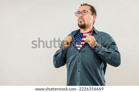 Fan man of 40s proud to show the jersey of the soccer team of his country USA under his shirt, on white background