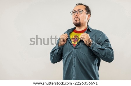 Fan man of 40s proud to show the jersey of the soccer team of his country Spain under his shirt, on white background