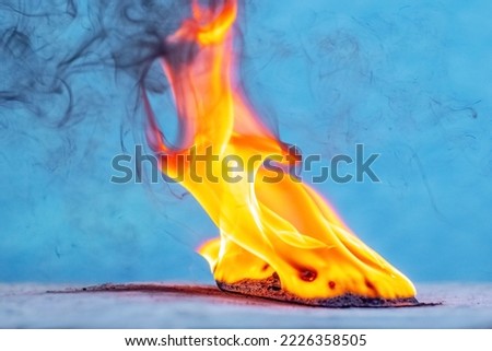 A mobile phone is burning in a strong flame