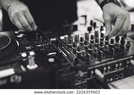 a DJ plays music on a controller at a party