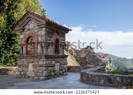 Very colorful picture of a small chapel located on the terrace of a meteor monastery (Varlaam or great meteor) in greece under a nice blue and white summer sky , kalambaca, greece