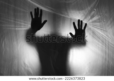 Male silhouette behind plastic curtain. Addiction way out concept Royalty-Free Stock Photo #2226373823