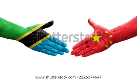 Handshake between China and Tanzania flags painted on hands, isolated transparent image.