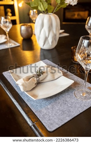 Decorative table setting with plate and wineglas Royalty-Free Stock Photo #2226386473