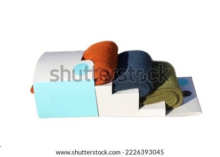 A set of men's multi-colored socks in a cardboard box