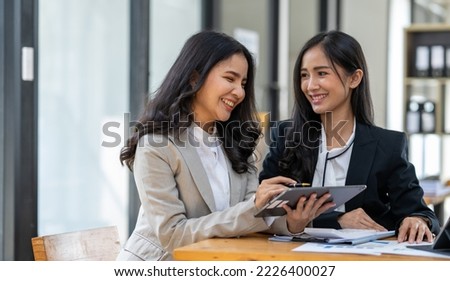 Asian female sales representatives in the section of Real estate talked and discussed tax plans to search for information Ask questions and give advice. All information is recorded and detailed. 


