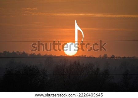 Sunset between power lines. The sun like a musical note at sunset.