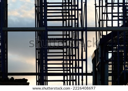 silhouette of building concrete structures with rebar against the background of the sunset sky. background. blank for the designer. for an article about construction or building infrastructure