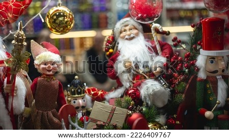 small trinkets of santa claus and his friends, various christmas decorations, visual with space and text area