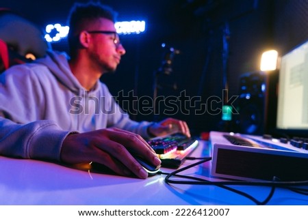 Producer, audio engineer uses a control panel and screen to record a track of a new album in a recording studio, in a soundproof room. Image producer, designer in working process