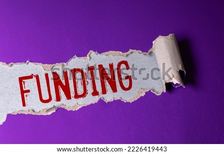 Funding symbol. Concept word Funding on wooden cubes. Beautiful white background. Business and Funding concept. Copy space.