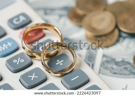 Save money and planning wedding concept. Sustainable financial goal for family life or married life. Rings with stack of coins, saving money for marry, depicts savings or growth for new family.