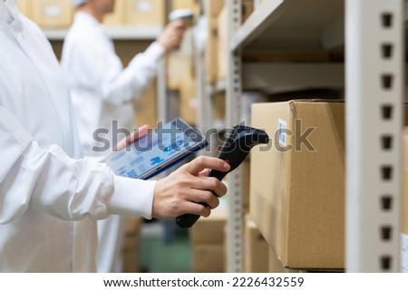 Warehouse management system with barcode reader and tablet PC. Inventory control. Royalty-Free Stock Photo #2226432559