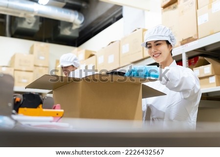 A woman packing food. Supply center of meals. Delivery food. Packaging factory.