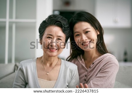 portrait of asian senior mother and adult daughter looking at camera smiling Royalty-Free Stock Photo #2226437815
