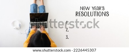 2023 new year resolution concept. Top view of woman sitting on the floor and using computer laptop Royalty-Free Stock Photo #2226445307