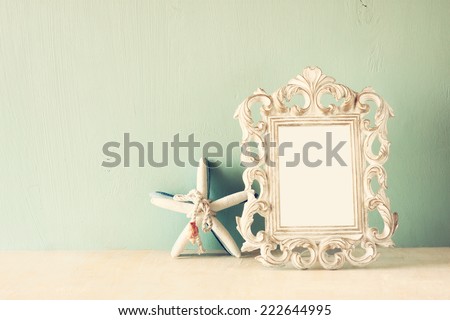 image of vintage antique classical frame and Starfish on wooden table