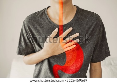 Young man having  heartburn, Gastroesophageal reflux disease (GERD) or acid reflux symptom, health care concept Royalty-Free Stock Photo #2226459569