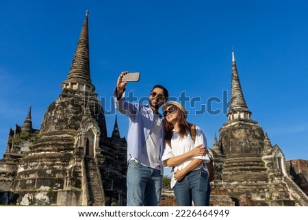 Couple of foreign tourists take selfie photo at Wat Phra Si Sanphet temple, Ayutthaya Thailand, for travel, vacation, holiday, honeymoon and tourism