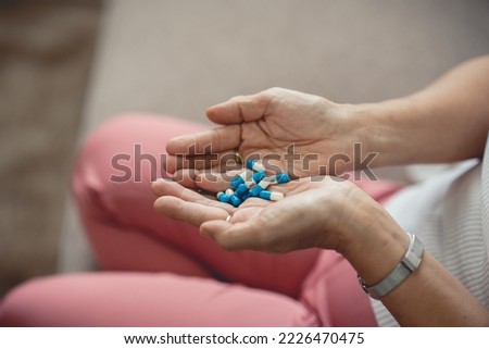The picture of the drug in the hand of an elderly woman is a patient who has to take regular medication every day.