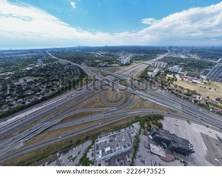 Highway for high speed commute and road traffic avoidance. Cars transportation junction development. Expressway in Canada view from above. Exit or entrance road lanes with speed ramps. 