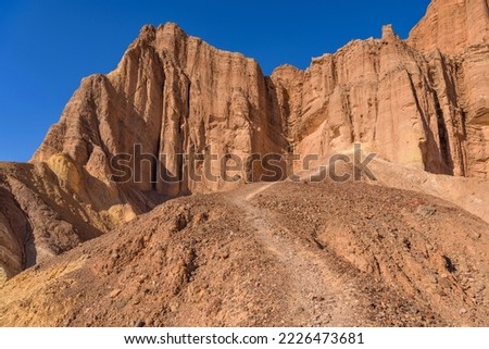 Red Cathedral - A rocky trail winding towards steep cliffs of Red Cathedral, Death Valley National Park, California, USA. Royalty-Free Stock Photo #2226473681