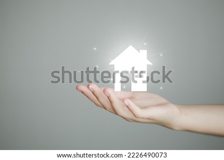 Real estate, House insurance, Property investment and asset management concept. Hand holding house. Decision to choose the best property with your right. Choosing suitable housing.