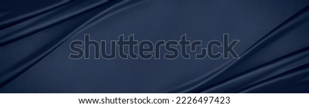 Dark blue silk satin. Soft folds. Fabric. Navy blue luxury background. Space for design.Wavy lines.Banner. Wide.Long. Flat lay, top view table. Beautiful. Elegant. Birthday, Christmas, Valentine's Day Royalty-Free Stock Photo #2226497423