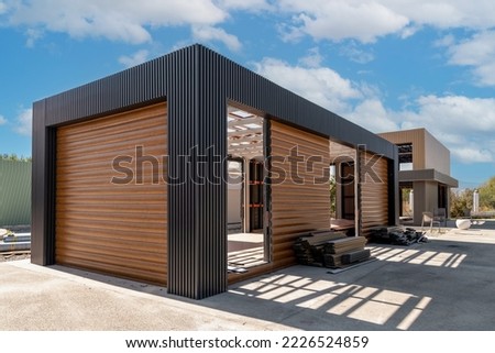Newly built metal framed building with siding. Construction of a new tiny house. selective focus Royalty-Free Stock Photo #2226524859
