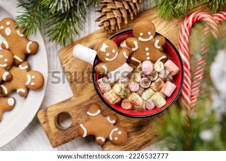 Gingerbread man cookies in a cup with marshmallow. Christmas holiday