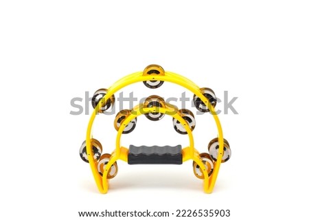 A tambourine with a plastic body and metal cymbals on a white background.