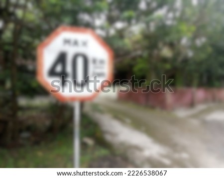 Blur photo of maximum speed sign with trees background.  suitable for transportation theme