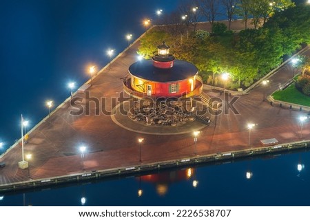 Red lighthouse at night, the Inner Harbor in Baltimore, Maryland USA Royalty-Free Stock Photo #2226538707