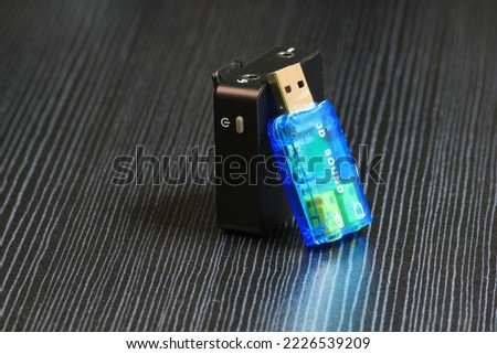 a clip-on wireless receiver with a blue soundcard