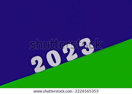 Happy New year 2023 number wood object on blue and red background and copy space. The colors of the flag of sierra leone