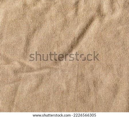 Light brown textured fabric with curves. High quality stock photo.