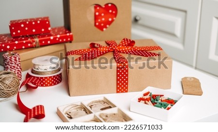 Christmas Gift ideas web banner. Red brown Xmas Gift box, kraft paper shopping bag and ribbons for wrapping. Sustainable Eco-Friendly zero waste Christmas Gift Boxes.