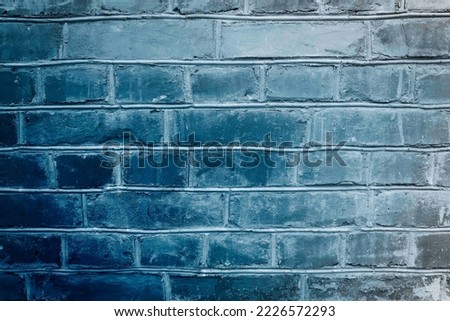 Toned blue brick wall surface. Neon effect ot background. Grunge backdrop.