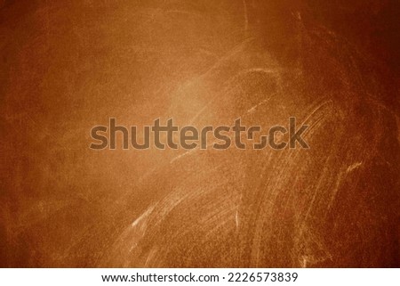 Chalk rubbed out on blackboard, orange or brown texture or background