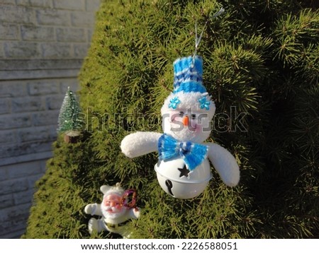 toy snowman. snowman on the tree. New Year. Christmas tree. vintage christmas toys. Snowman and christmas balls on snow. winter holidays.