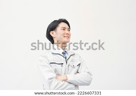 Portrait of Asian worker smiling in white background Royalty-Free Stock Photo #2226607331