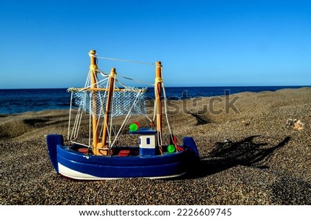 Photo Picture of a Toy Boat on the Sand Beach