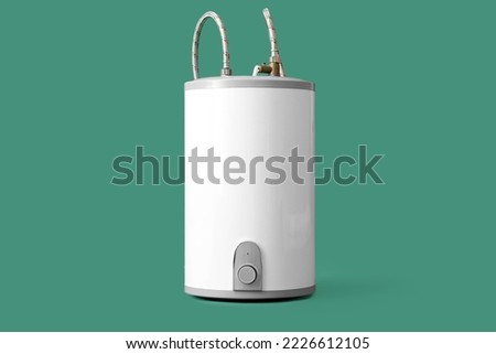 Modern electric boiler on green background Royalty-Free Stock Photo #2226612105