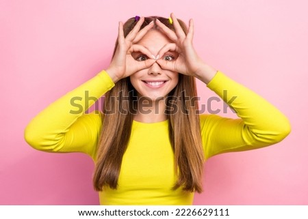 Photo of charming funky school girl dressed yellow top showing arms spectacles having fun isolated pink color background