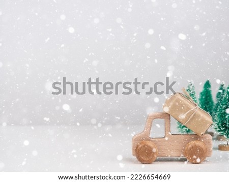Wooden car with a gift. The concept of a Christmas sale.Space for text.