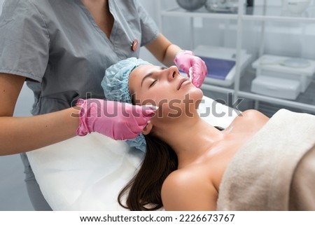 A professional beautician performs a mechanical facial cleansing procedure at the spa. Beautiful caucasian woman on a cosmetic procedure. health Center